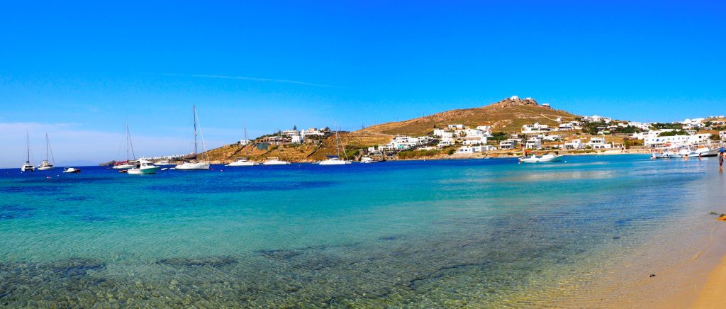 Panoramic view of the south beach of Ornos in Mykonos, the famous Greek island of the Cyclades archipelago in the heart of the Aegean Sea