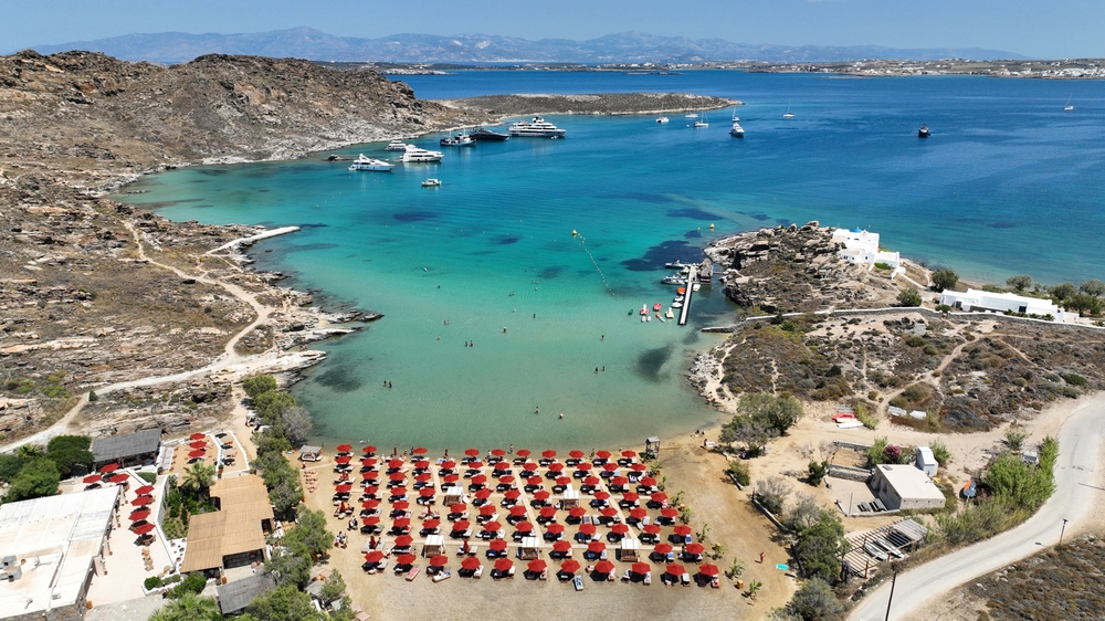 Aerial drone photo of famous small organised beach of Monastiri in the gulf of Naousa, Paros island, Cyclades, Greece - Aerial-motion / shutterstock